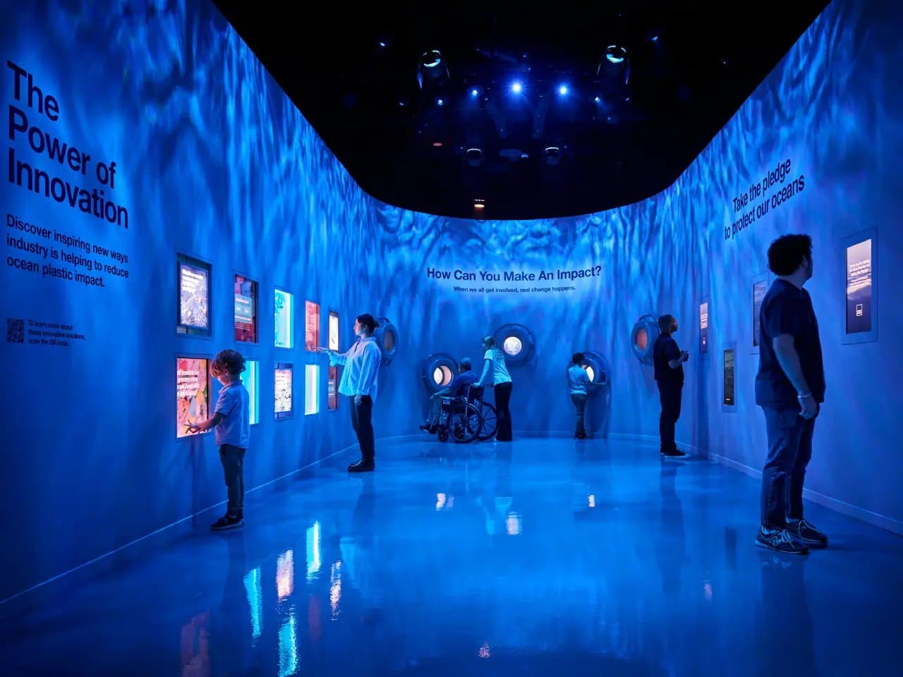 People interact with illuminated displays on ocean innovation in a blue-lit room. Text includes: "The Power of Innovation," "How Can You Make An Impact?" and "Take the pledge to protect our oceans."