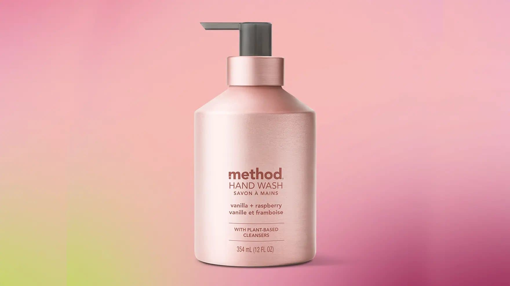 A pink pump bottle labeled "method HAND WASH," featuring "vanilla + raspberry" scent with plant-based cleansers, sits against a gradient pink background. The bottle size is 354 mL (12 FL OZ).