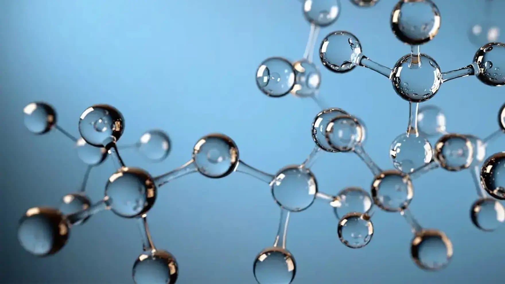 Shiny, translucent molecular structure appears interconnected with spherical nodes and rods, floating against a smooth, light blue background.